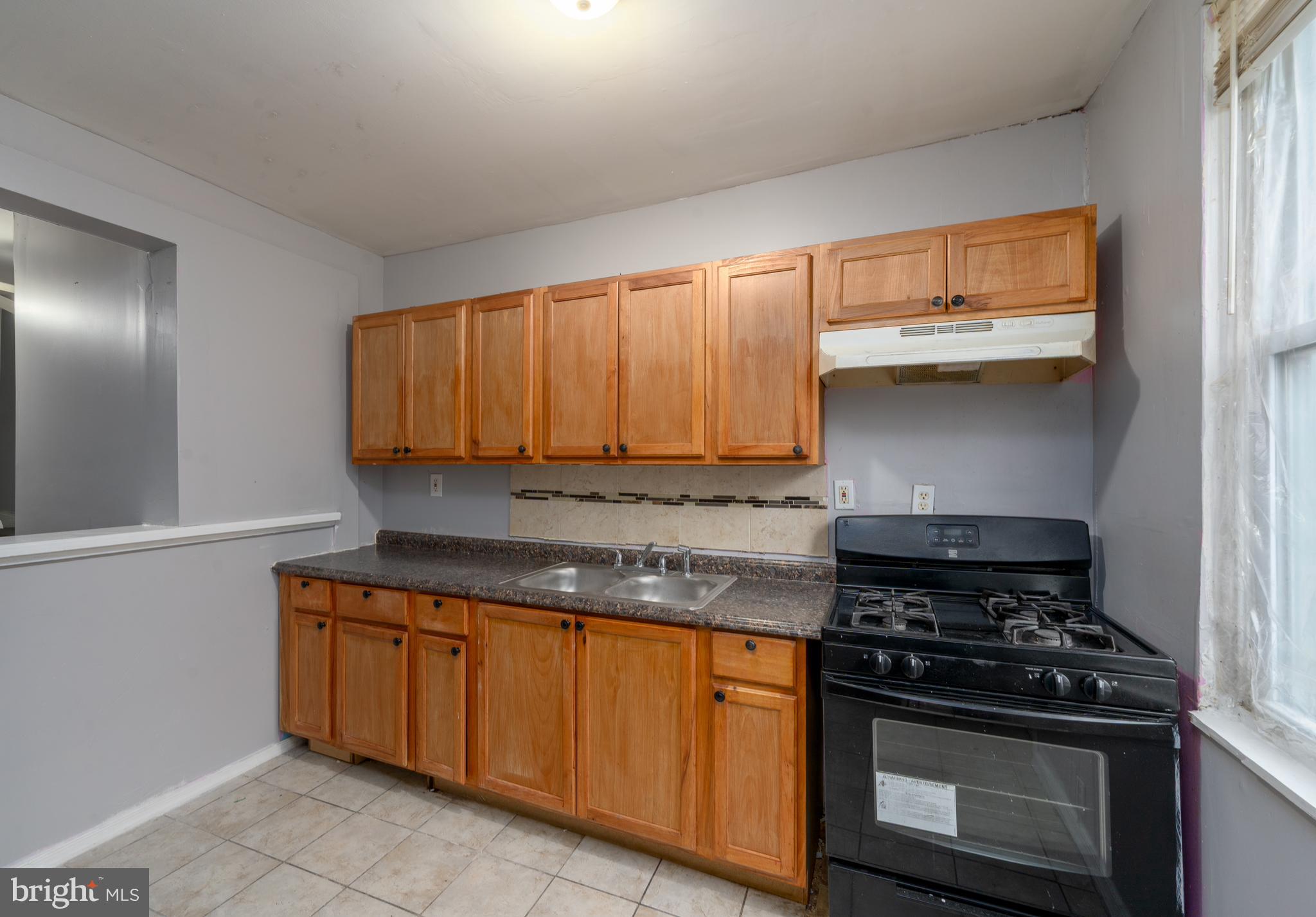 430 South Payson Street Baltimore, MD 21223 - Photo 13 of 29 a kitchen with granite countertop a stove and a sink