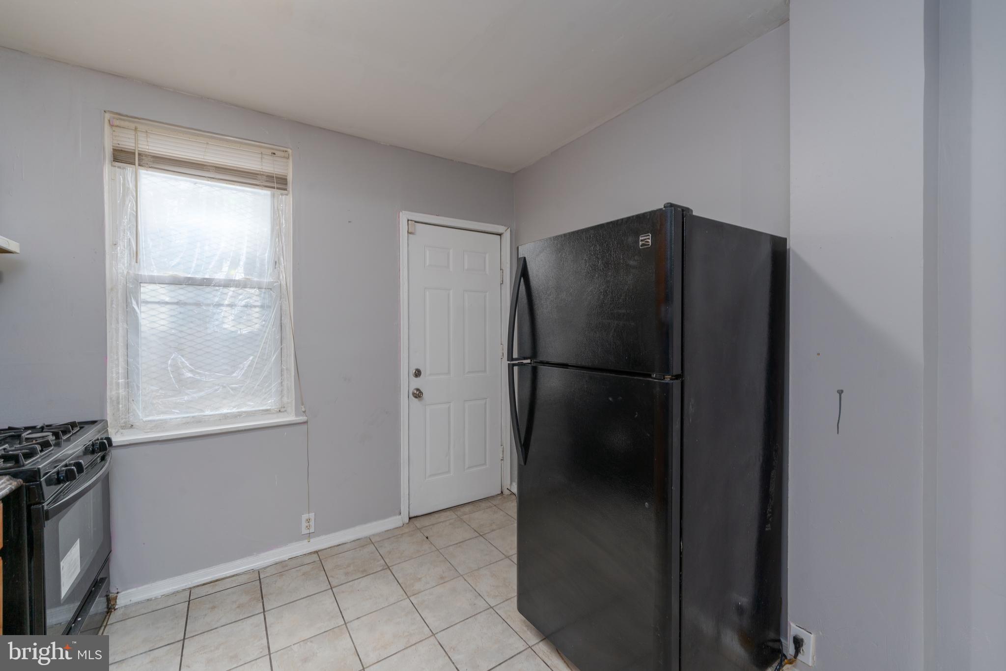 430 South Payson Street Baltimore, MD 21223 - Photo 14 of 29 a metallic refrigerator freezer sitting in a kitchen
