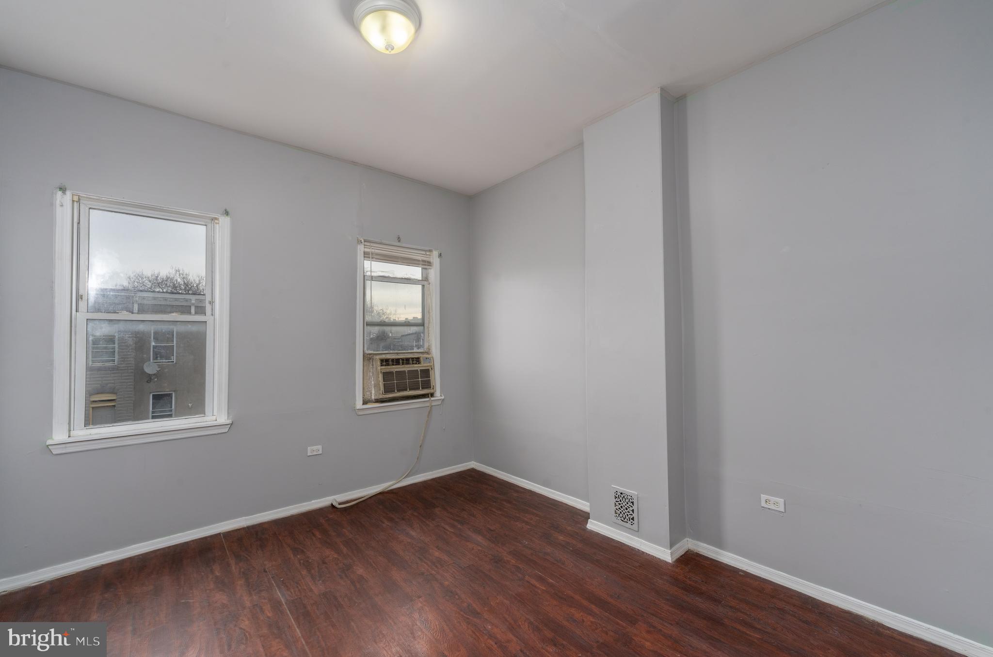 430 South Payson Street Baltimore, MD 21223 - Photo 15 of 29 a view of an empty room with wooden floor and a window