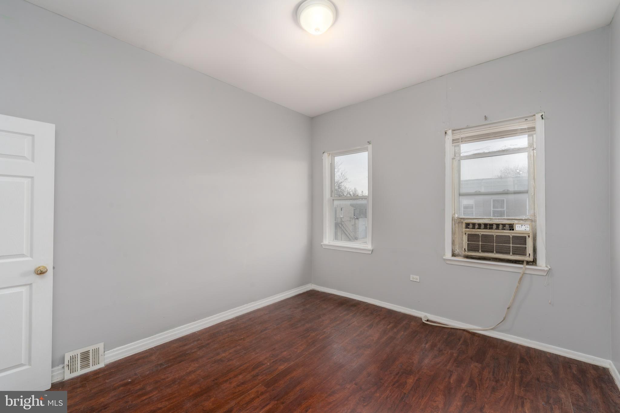 430 South Payson Street Baltimore, MD 21223 - Photo 17 of 29 an empty room with wooden floor and windows