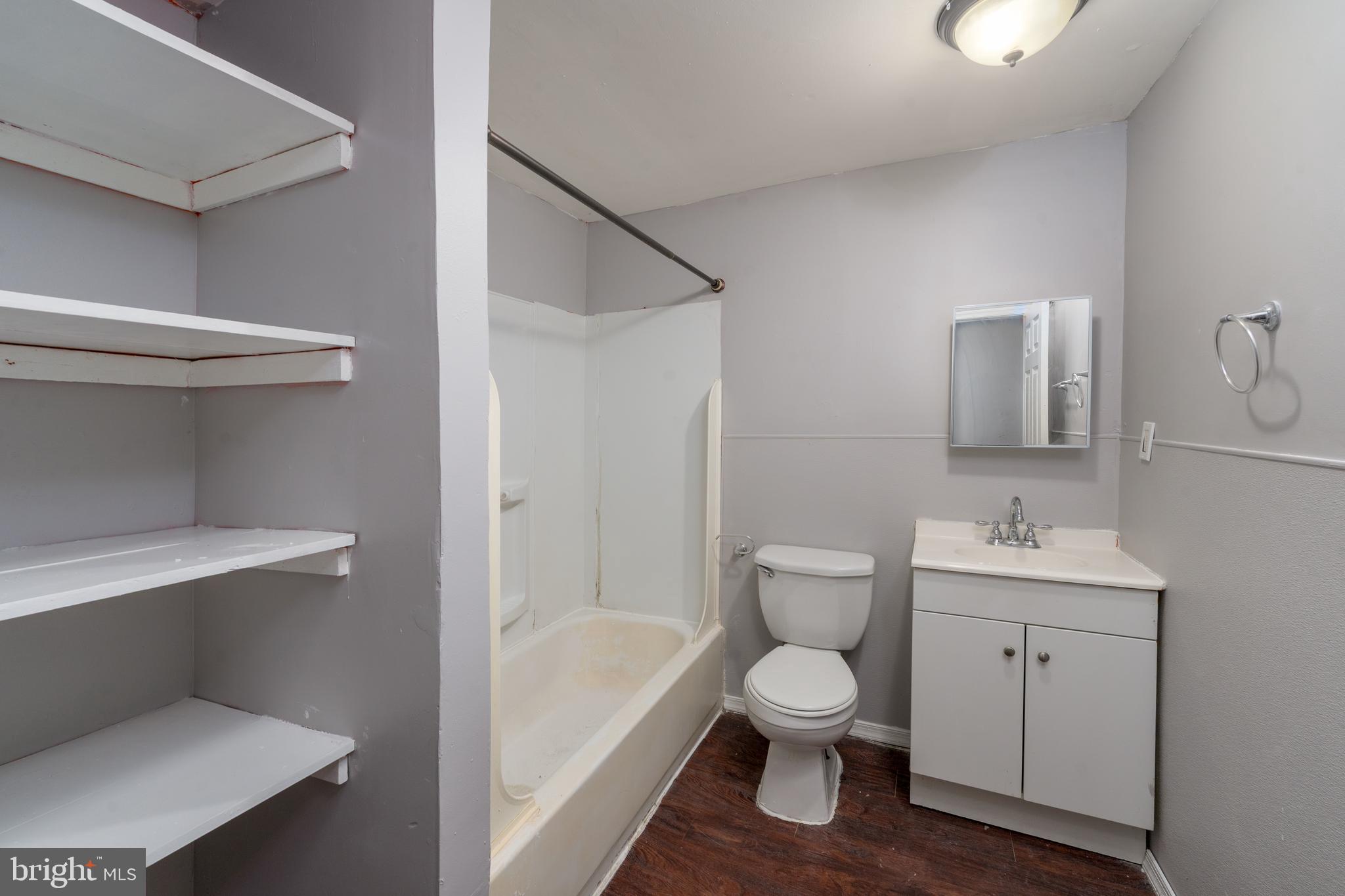 430 South Payson Street Baltimore, MD 21223 - Photo 19 of 29 a bathroom with a toilet sink and mirror