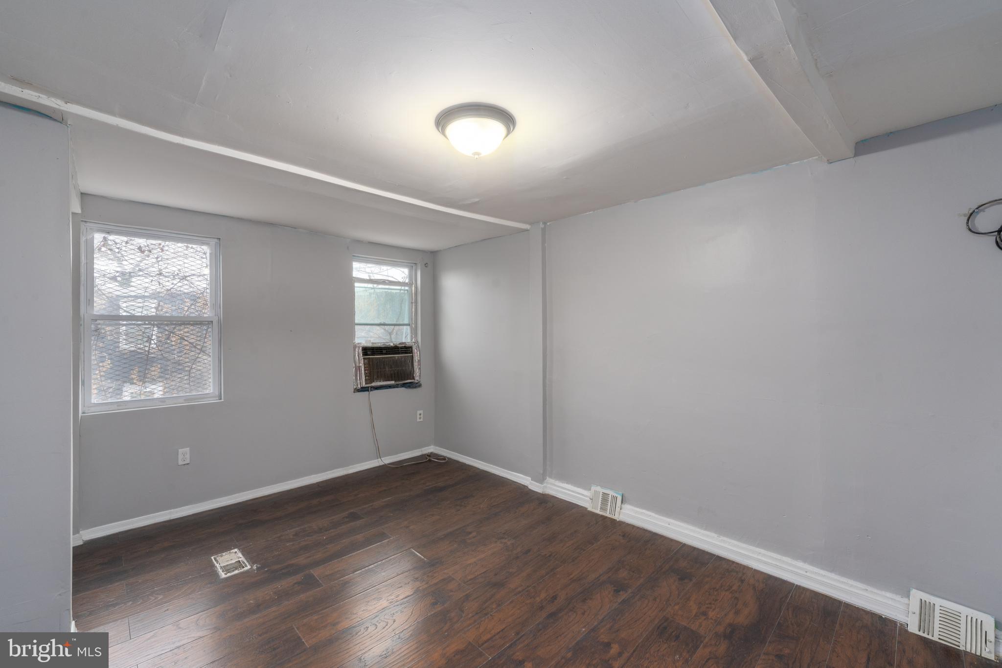 430 South Payson Street Baltimore, MD 21223 - Photo 20 of 29 an empty room with wooden floor and windows