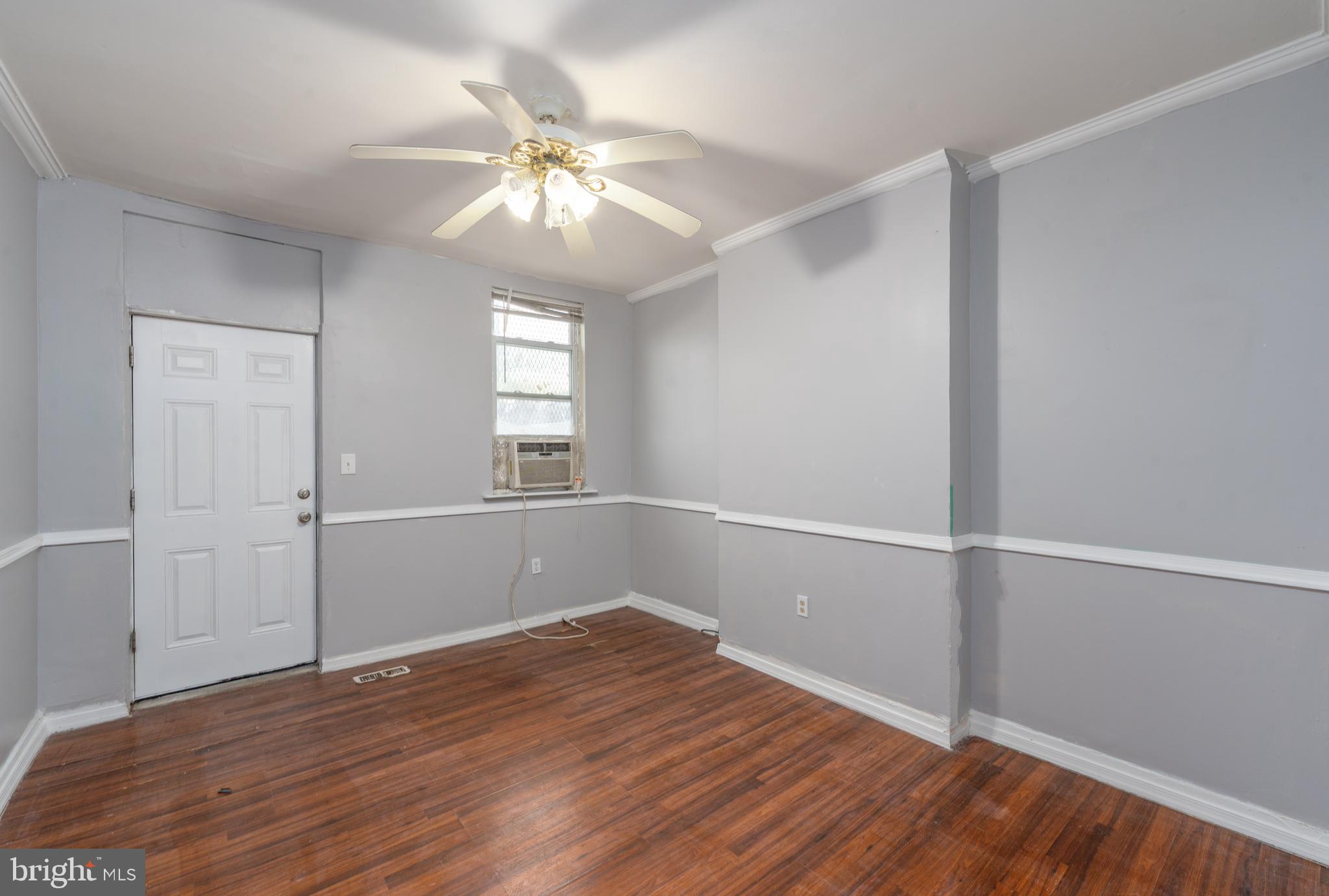 430 South Payson Street Baltimore, MD 21223 - Photo 4 of 29 wooden floor in an empty room with a window