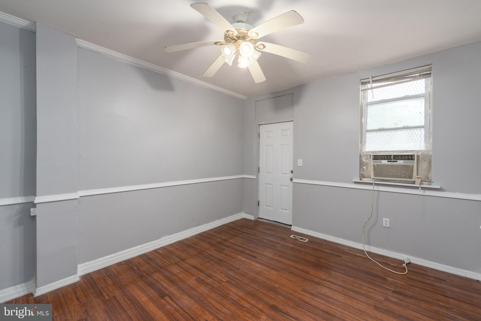 430 South Payson Street Baltimore, MD 21223 - Photo 5 of 29 an empty room with wooden floor and windows