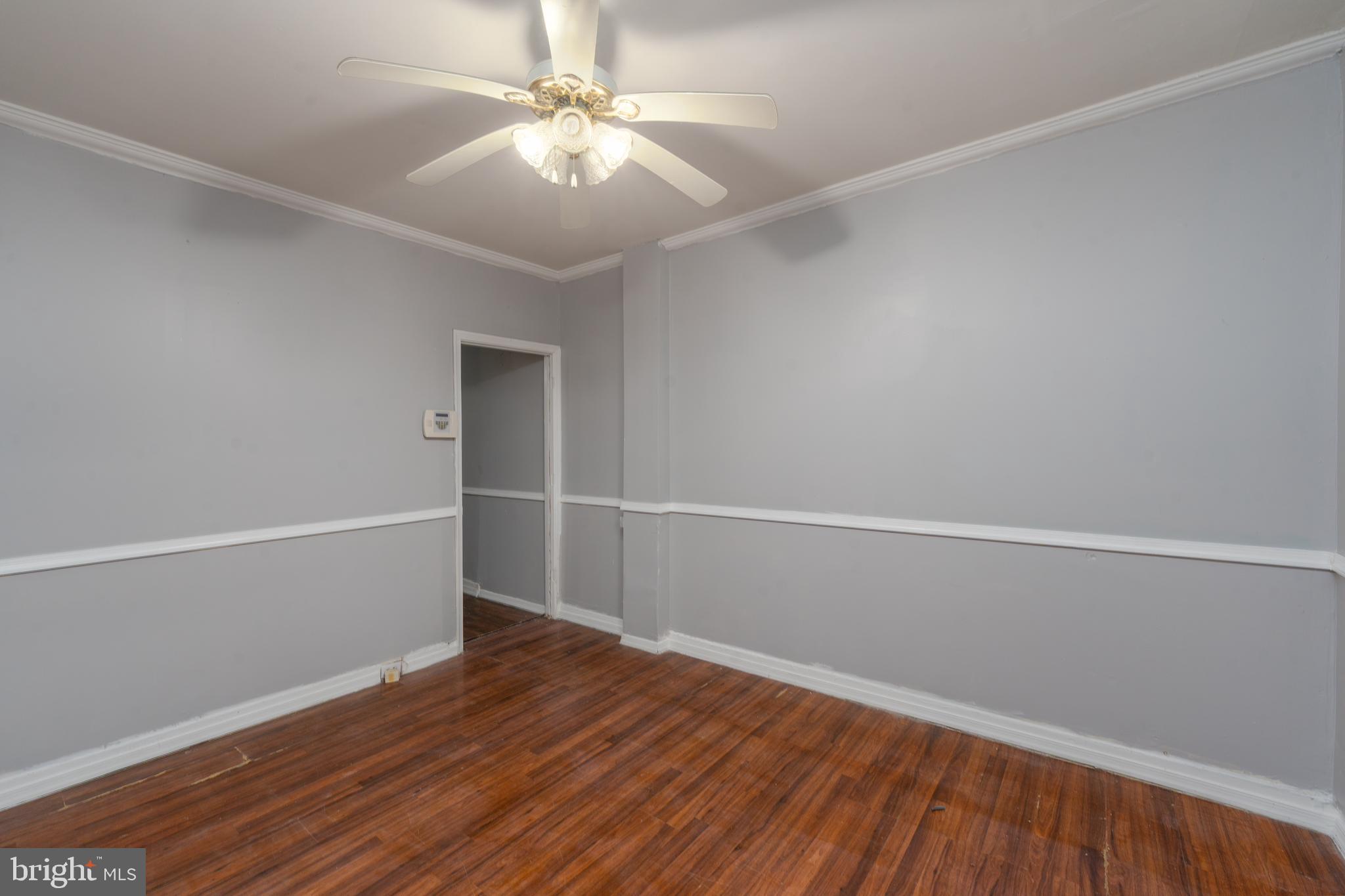 430 South Payson Street Baltimore, MD 21223 - Photo 6 of 29 an empty room with wooden floor and fan