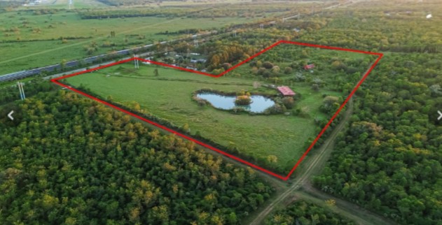 a view of a back yard of the house and a yard