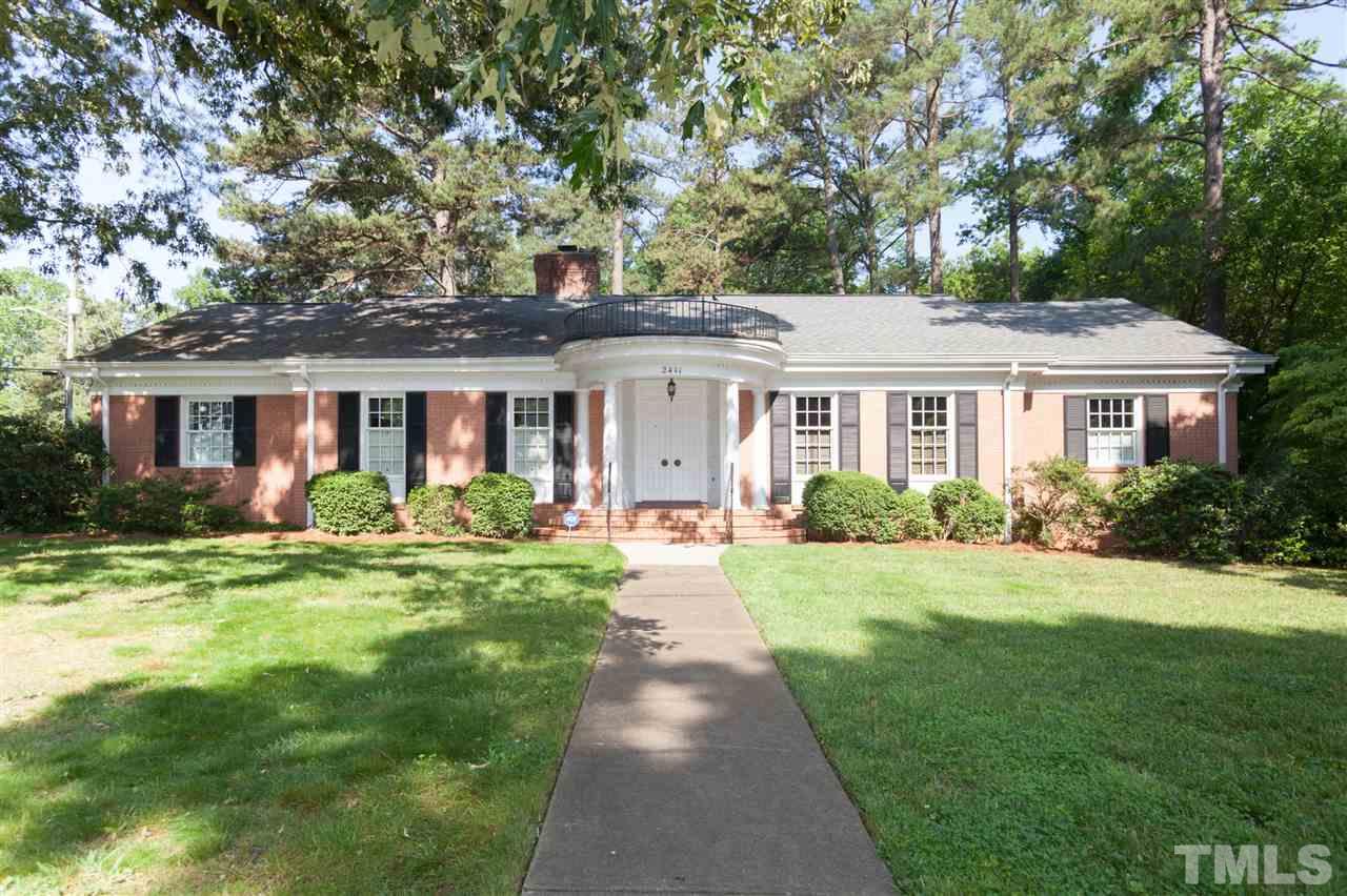 a front view of a house with yard patio and green space