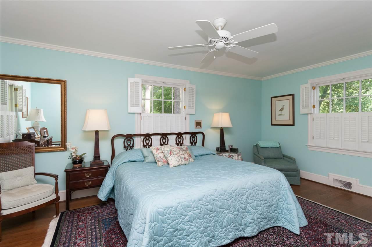 2401 Ridge Road Raleigh, NC 27612 - Photo 11 of 24 a bed room with a bed and a lamp