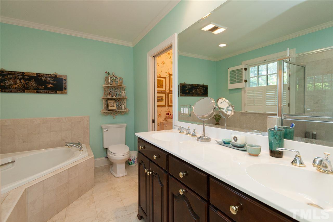 2401 Ridge Road Raleigh, NC 27612 - Photo 12 of 24 a bathroom with a tub double sink and mirror