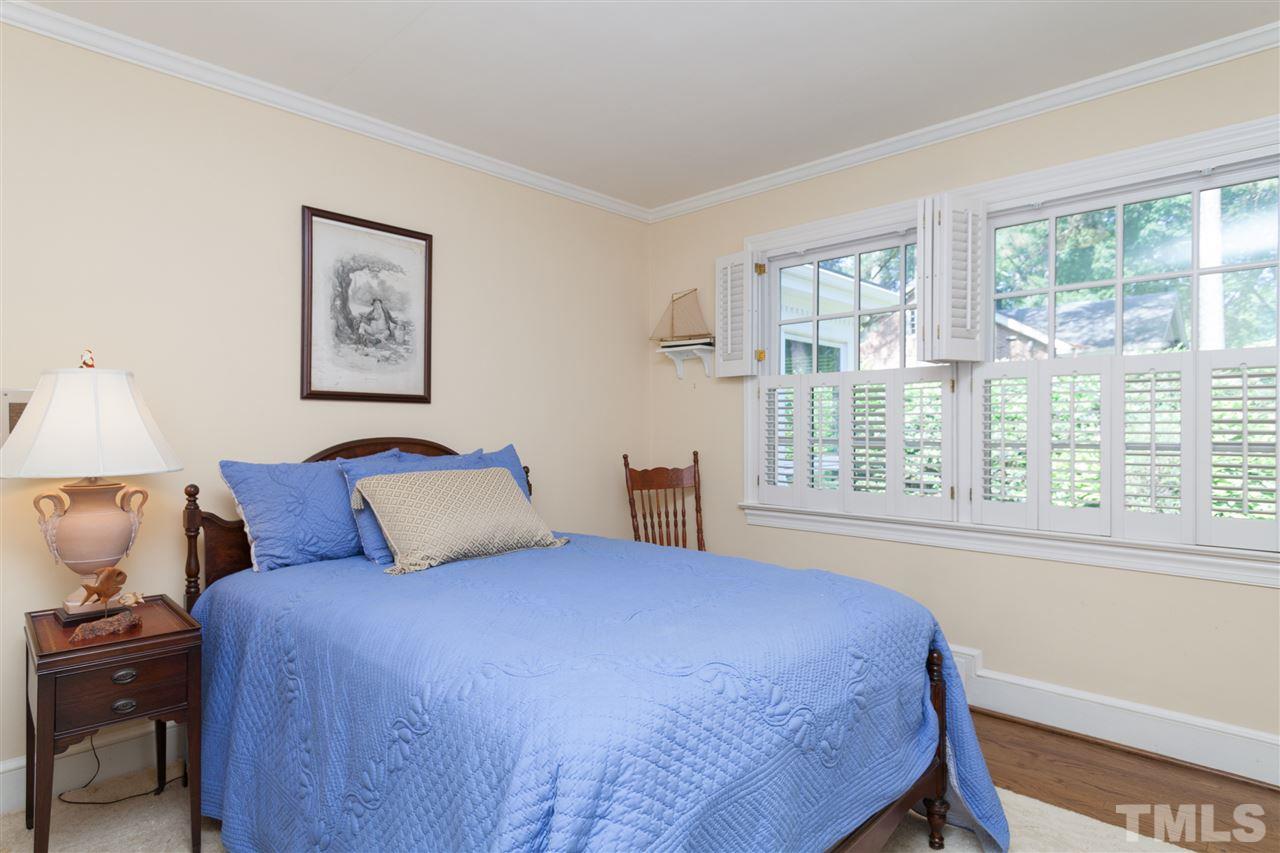 2401 Ridge Road Raleigh, NC 27612 - Photo 16 of 24 a bedroom with a large bed and a window
