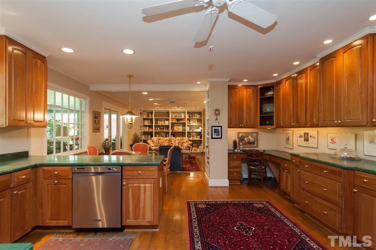 2401 Ridge Road Raleigh, NC 27612 - Photo 6 of 24 a kitchen with stainless steel appliances granite countertop a sink a stove and a refrigerator
