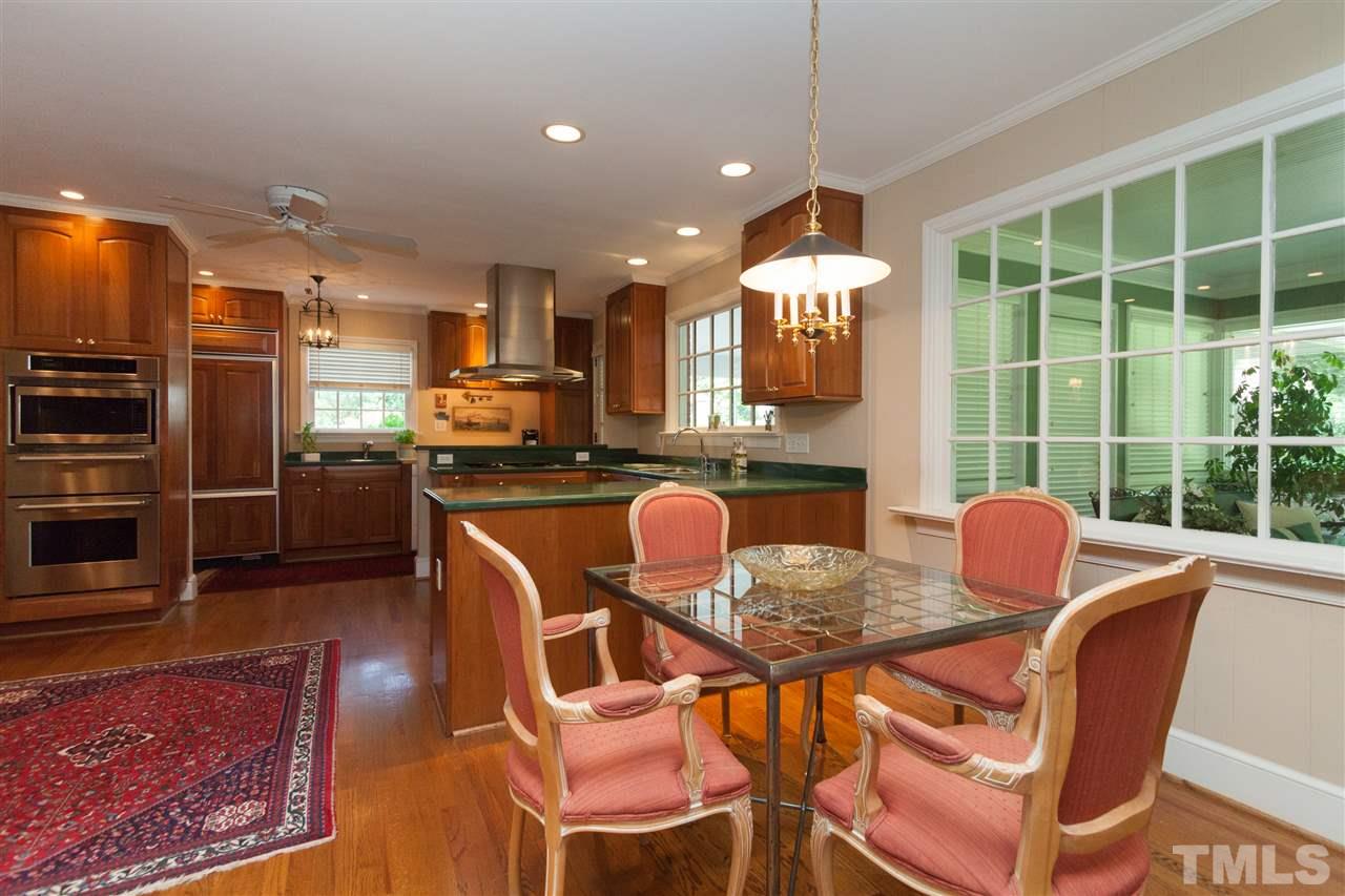 2401 Ridge Road Raleigh, NC 27612 - Photo 8 of 24 a dining room with furniture and a floor to ceiling window
