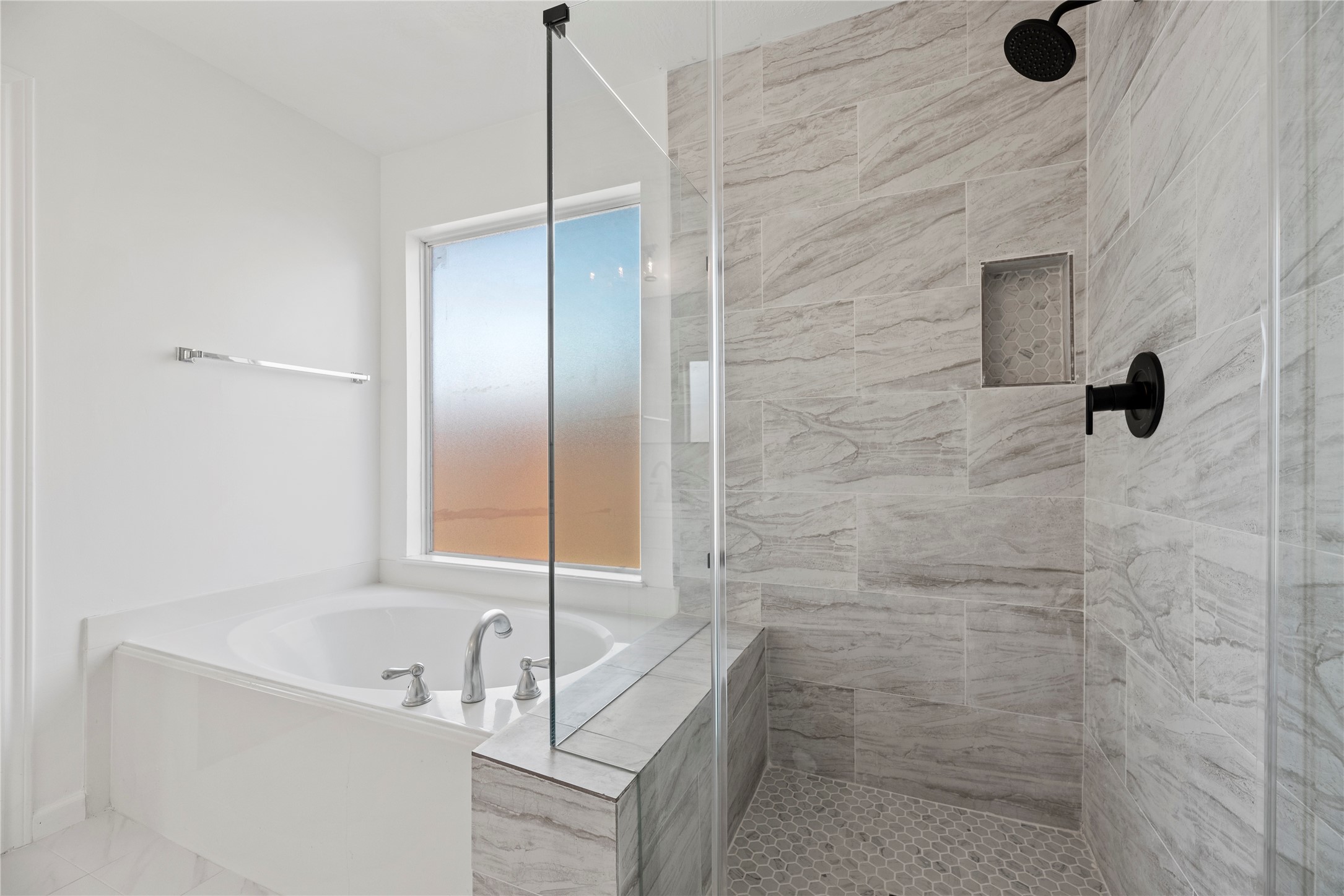 19910 Rustic Lake Lane Cypress, TX 77433 - Photo 8 of 21 This renovated bathroom comes with a soaking tub, separate vanities, a modern glass-enclosed shower with beautiful tile work throughout and plenty of space in this light and bright primary bathroom.