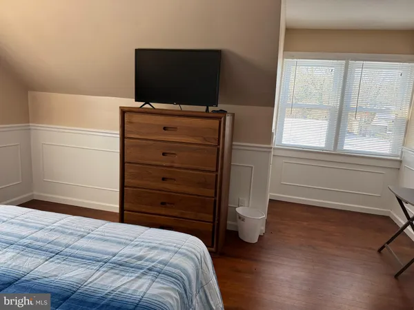 a bedroom with a bed and a television