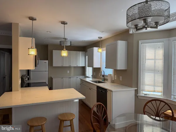 a kitchen that has a sink a stove and a table