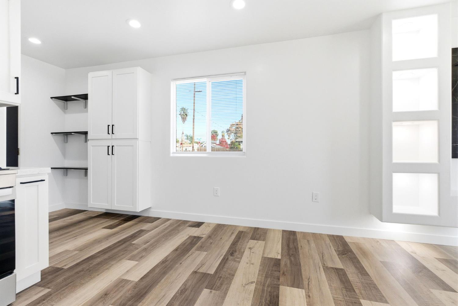 3763 East Verrue Avenue Fresno, CA 93702 - Photo 11 of 24 a view of empty room with wooden floor and windows