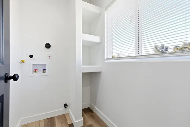 a view of bedroom with wooden floor