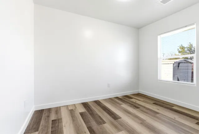 a bathroom with a sink a toilet a mirror and shower
