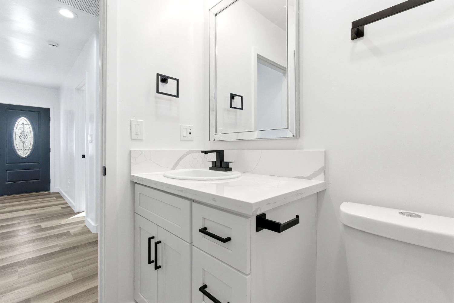 3763 East Verrue Avenue Fresno, CA 93702 - Photo 20 of 24 a bathroom with a sink a toilet a mirror and shower