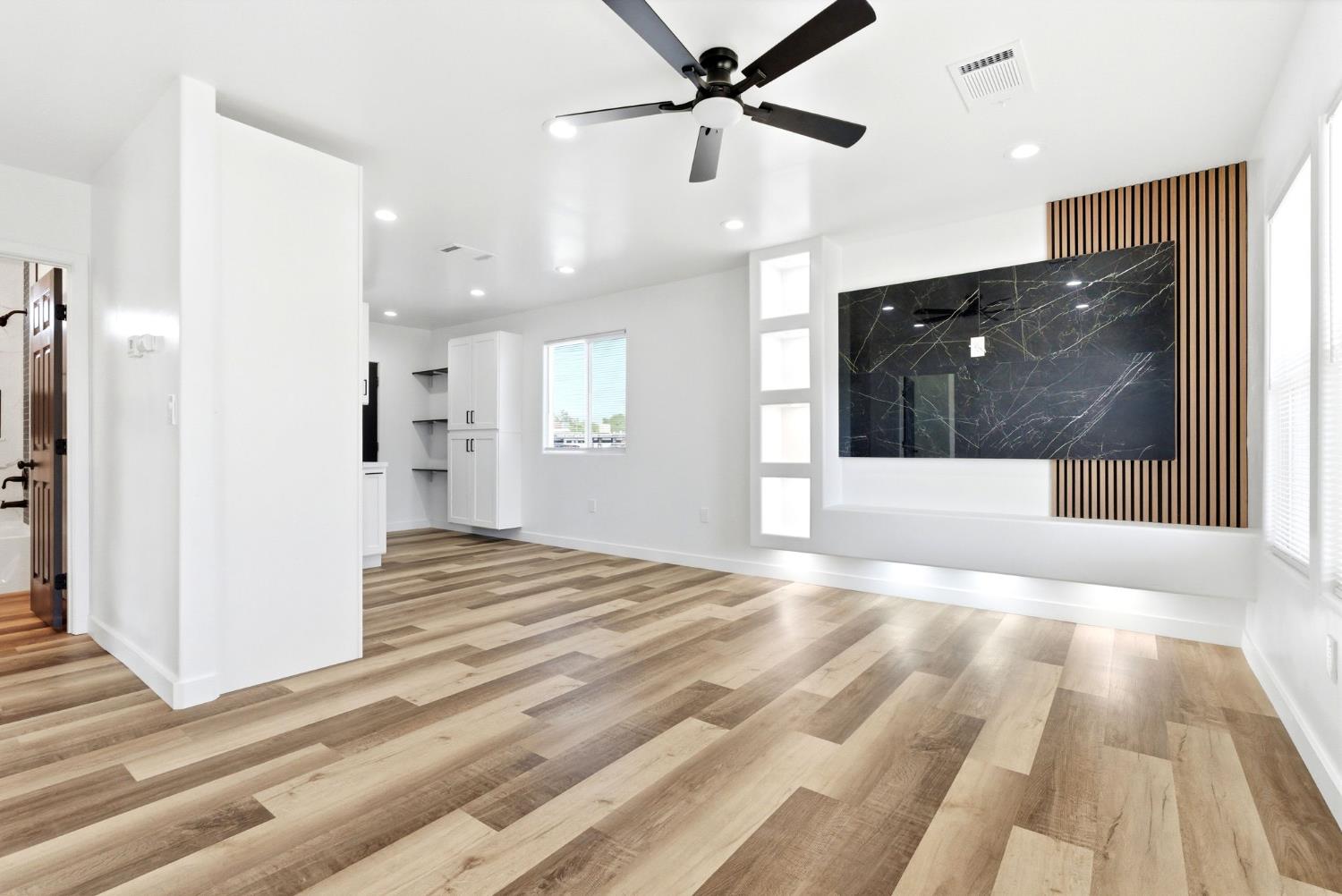 3763 East Verrue Avenue Fresno, CA 93702 - Photo 5 of 24 a view of empty room with wooden floor and fan