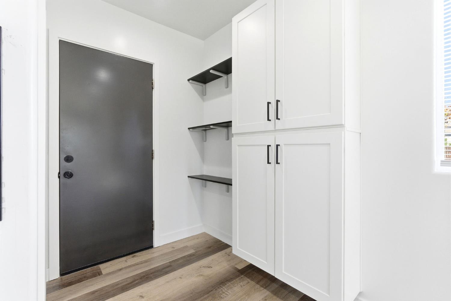 3763 East Verrue Avenue Fresno, CA 93702 - Photo 10 of 24 a view of a hallway with wooden floor