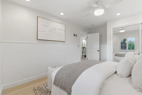 a bedroom with a bed and a painting on the wall
