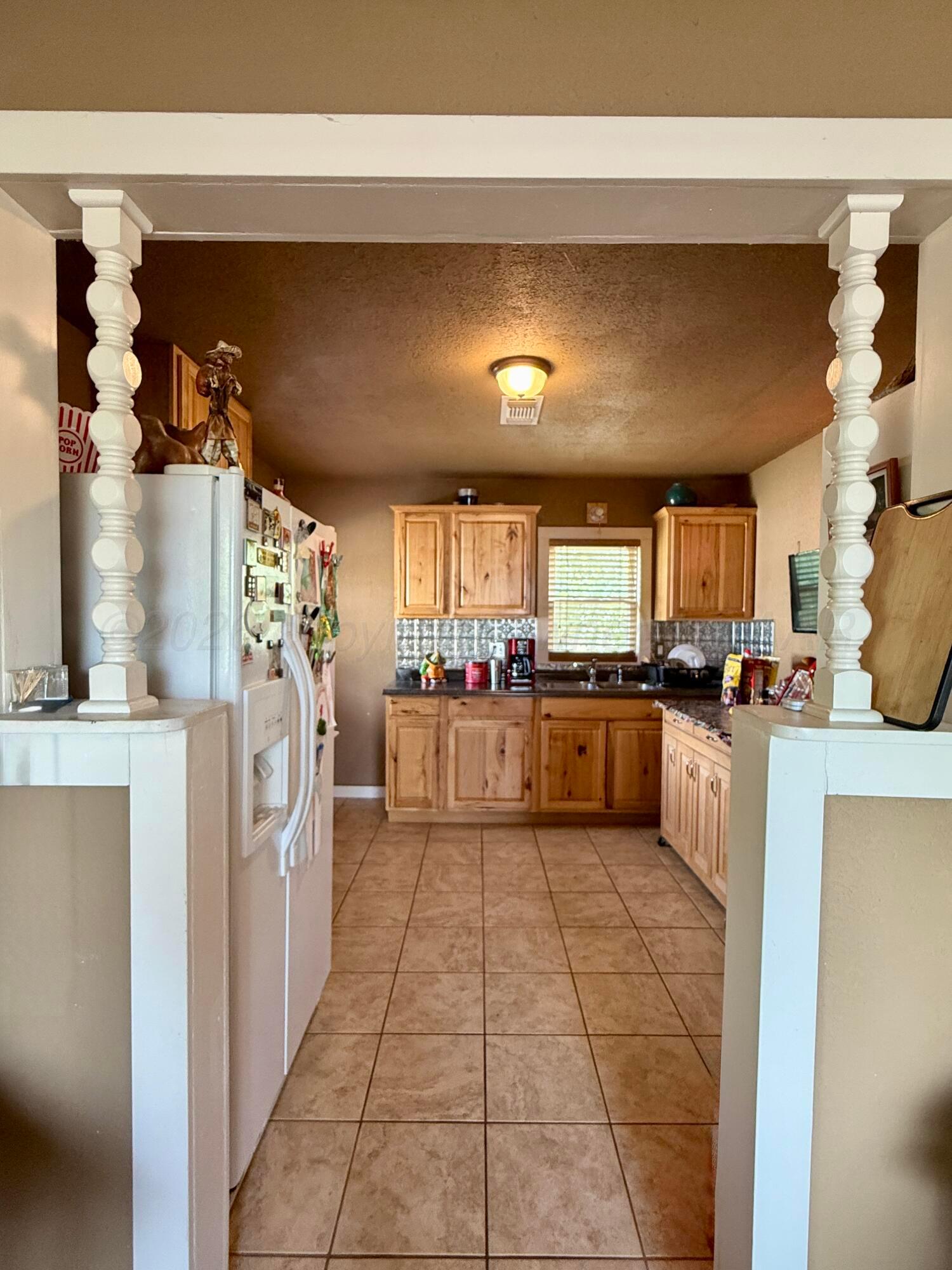 701 Brain Street Borger, TX 79007 - Photo 17 of 18 a kitchen with stainless steel appliances granite countertop a refrigerator and a stove