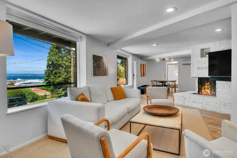 a living room with patio furniture and a flat screen tv