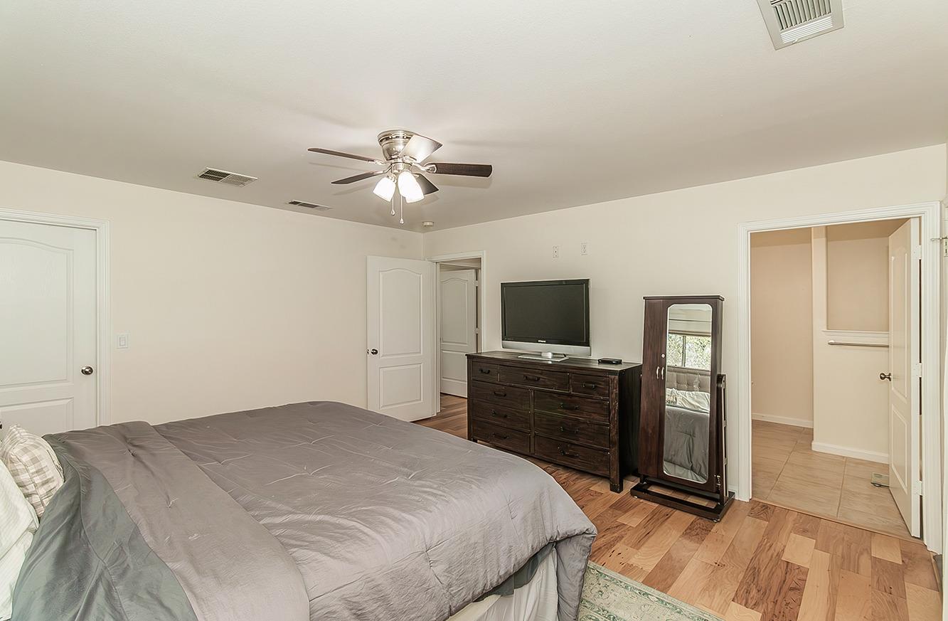 29039 Auberry Road Prather, CA 93651 - Photo 17 of 73 a bedroom with a bed and a flat screen tv