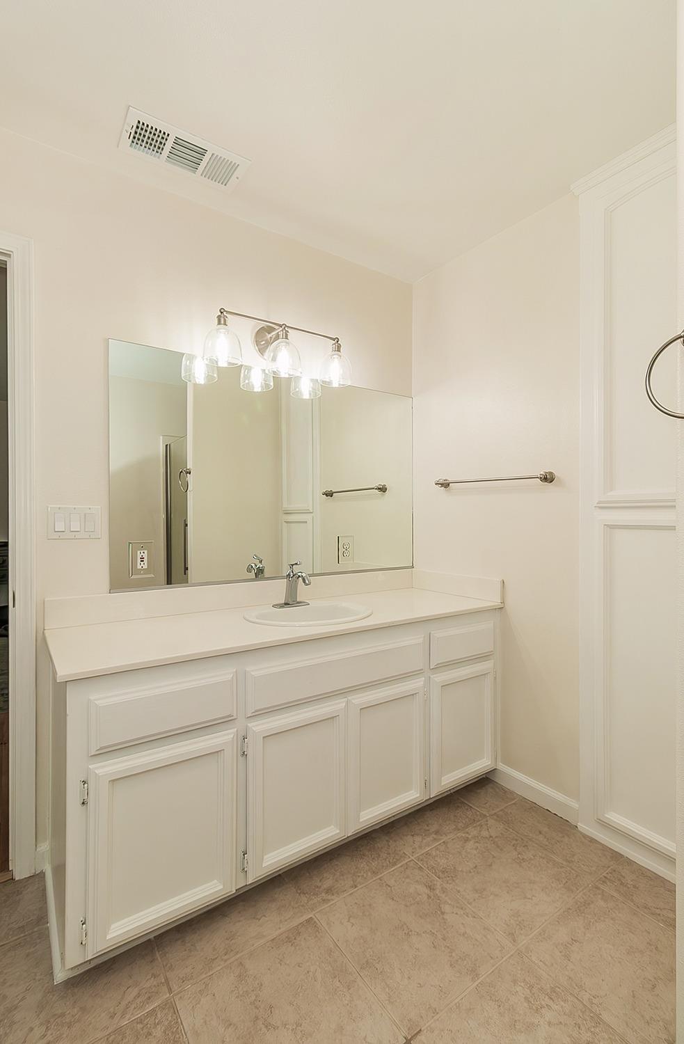 29039 Auberry Road Prather, CA 93651 - Photo 18 of 73 a spacious bathroom with a double vanity sink and a mirror