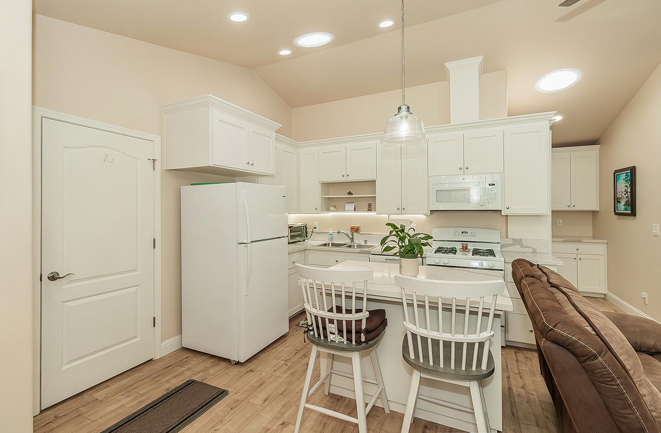 29039 Auberry Road Prather, CA 93651 - Photo 31 of 73 a kitchen with kitchen island wooden cabinets and refrigerator
