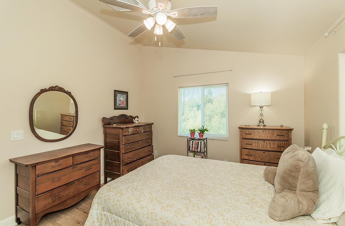 29039 Auberry Road Prather, CA 93651 - Photo 37 of 73 a bed room with a bed and a chandelier