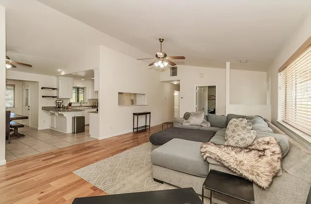 a kitchen with granite countertop white cabinets and stainless steel appliances