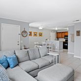 a living room with furniture and kitchen view