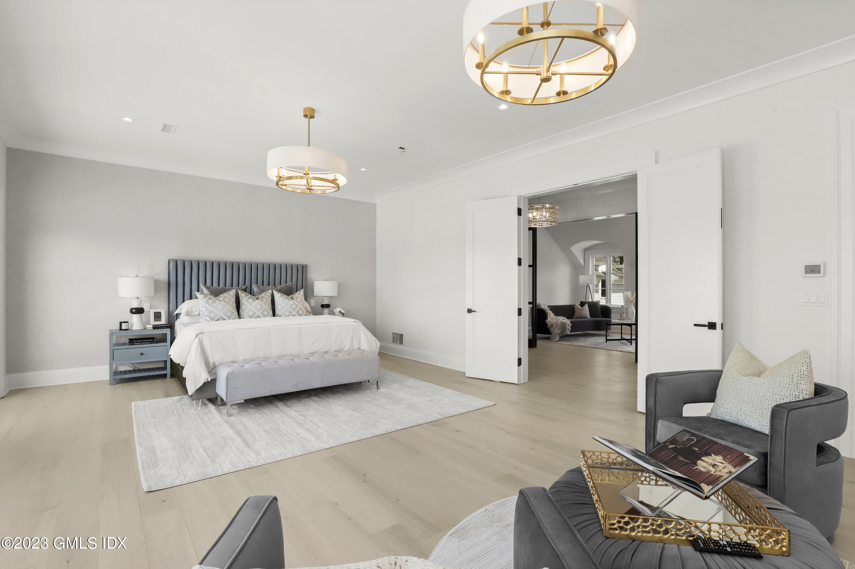 32 Meadowcroft Lane Greenwich, CT 06830 - Photo 15 of 43 a bedroom with a bed and a chandelier