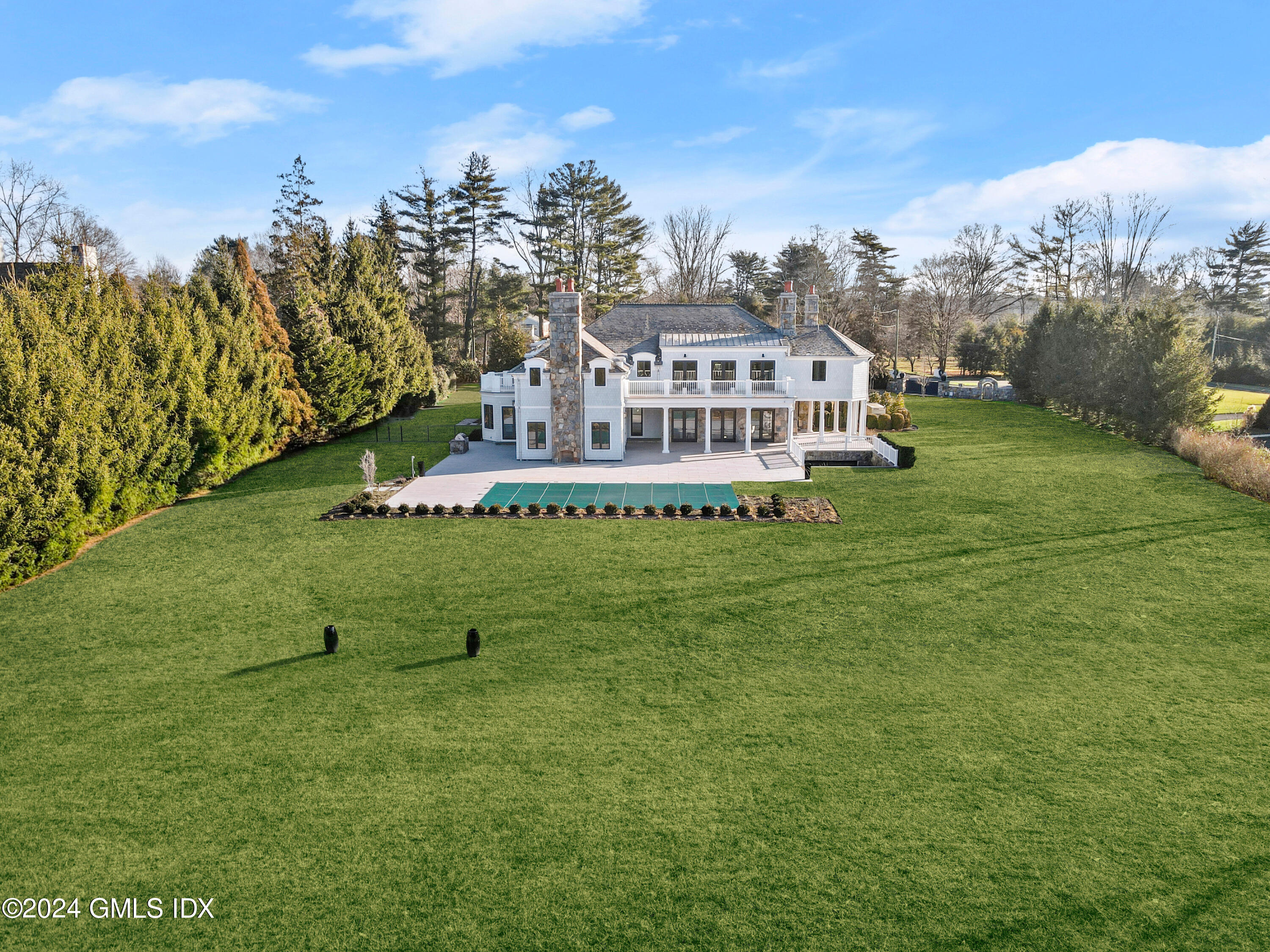 32 Meadowcroft Lane Greenwich, CT 06830 - Photo 39 of 43 a view of a house with a big yard and large trees
