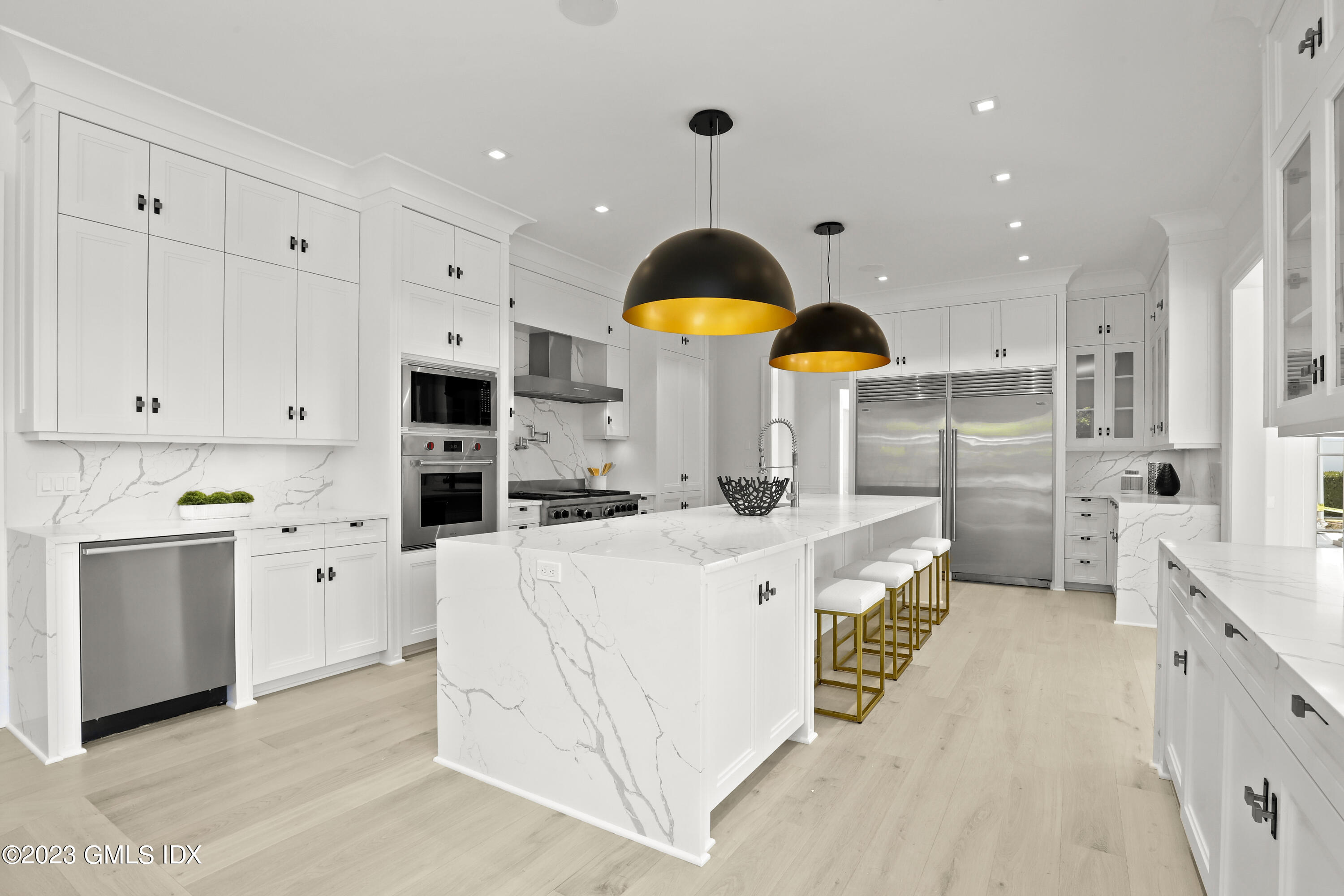 32 Meadowcroft Lane Greenwich, CT 06830 - Photo 9 of 43 a large kitchen with stainless steel appliances kitchen island granite countertop a stove a sink a refrigerator and white cabinets