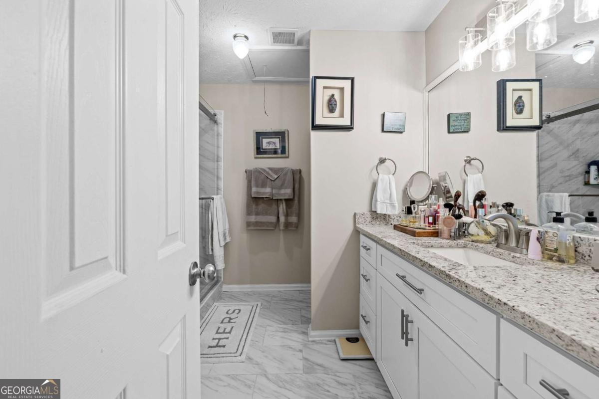 6324 Amberly Road Rex, GA 30273 - Photo 17 of 22 a bathroom with a granite countertop sink and a mirror