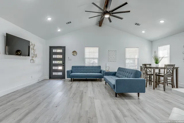 a living room with furniture and a flat screen tv