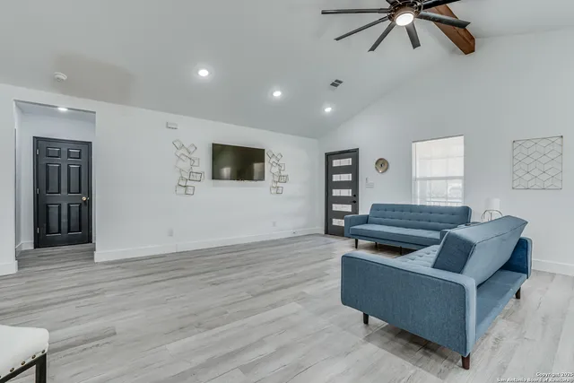 a living room with furniture and a flat screen tv