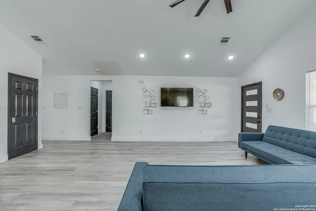 a living room with furniture and kitchen view