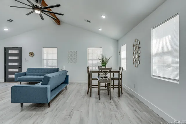 a view of a dining room with furniture and wooden floor