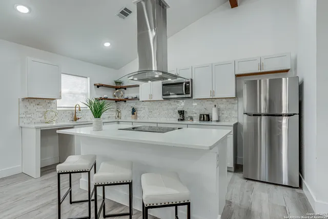 a kitchen with a table and chairs in it