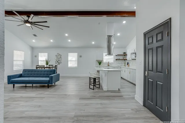 a spacious bedroom with a bed and a window