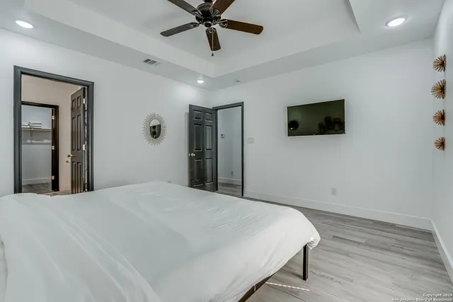 a bathroom with a granite countertop shower and a toilet
