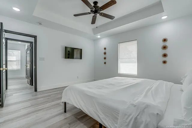 a bedroom with two beds and a chandelier
