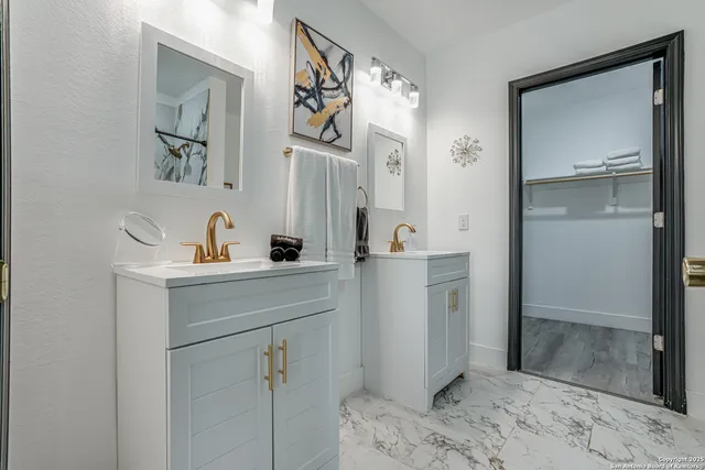 a bedroom with two beds and painting on the wall