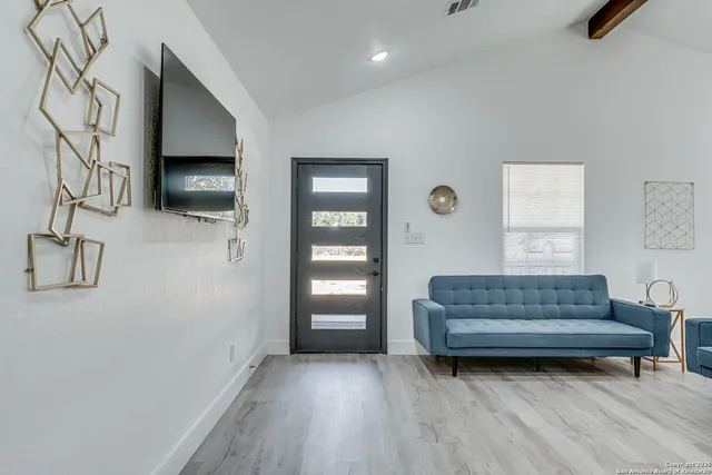 a living room with furniture and a flat screen tv