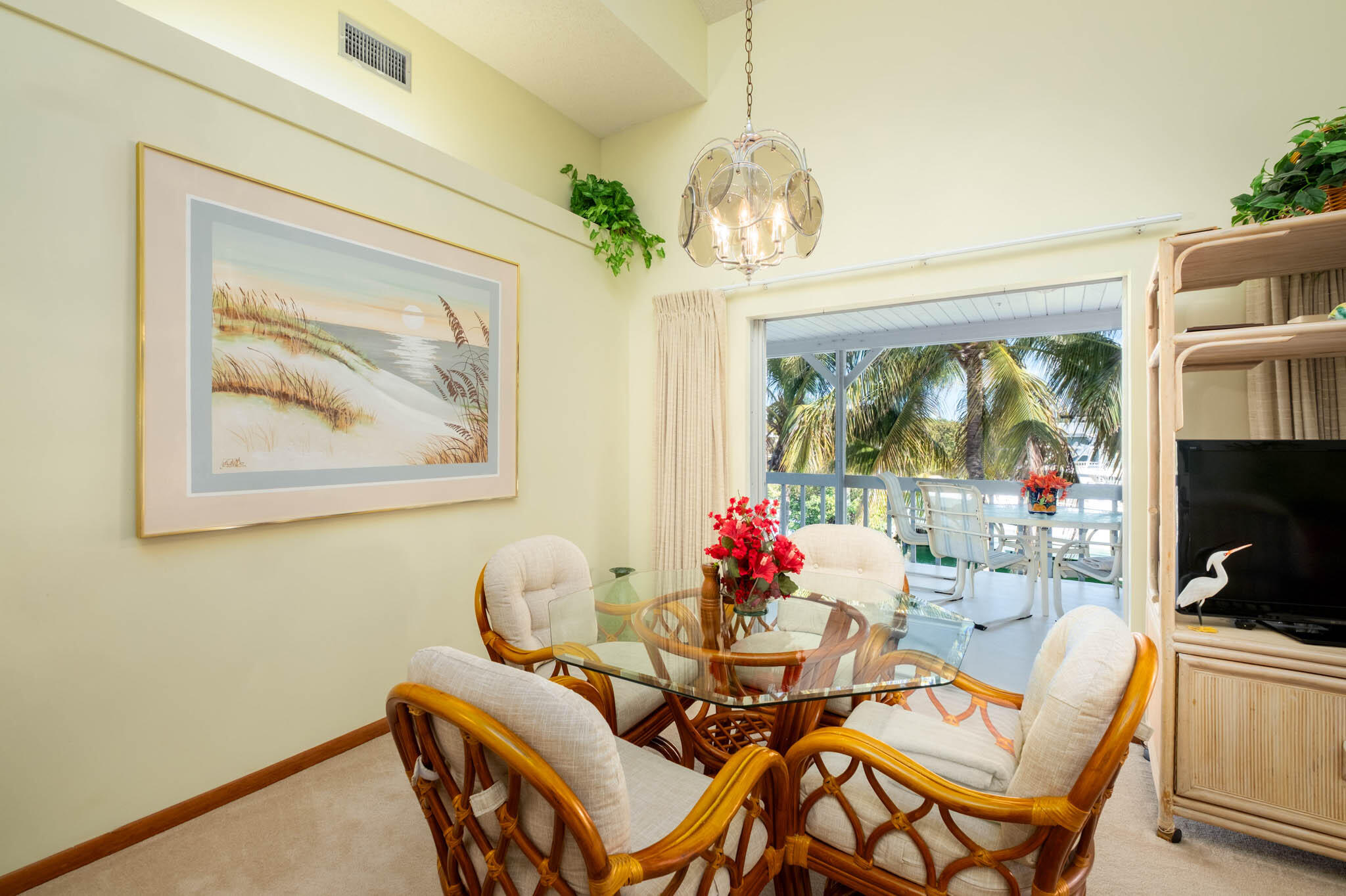 216 Sonny Road Tavernier, FL 33070 - Photo 13 of 49 a view of a dining room with furniture a chandelier and window