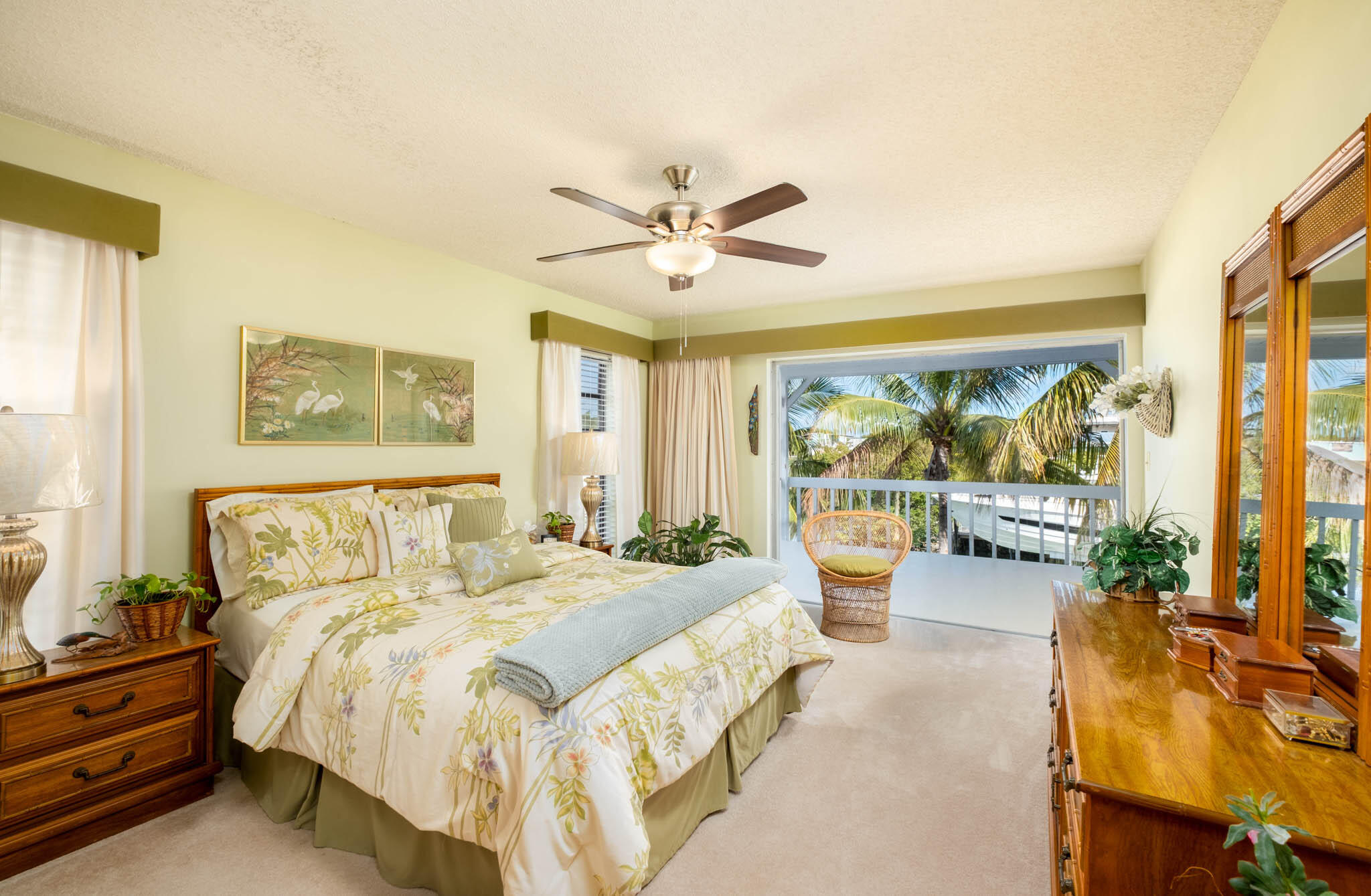 216 Sonny Road Tavernier, FL 33070 - Photo 19 of 49 a bedroom with a bed a couch and a large window with outer view